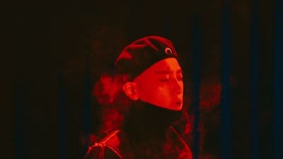 a man wearing a red hat and a black jacket