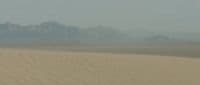a person riding a horse in the desert