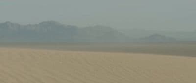 a person riding a horse in the desert