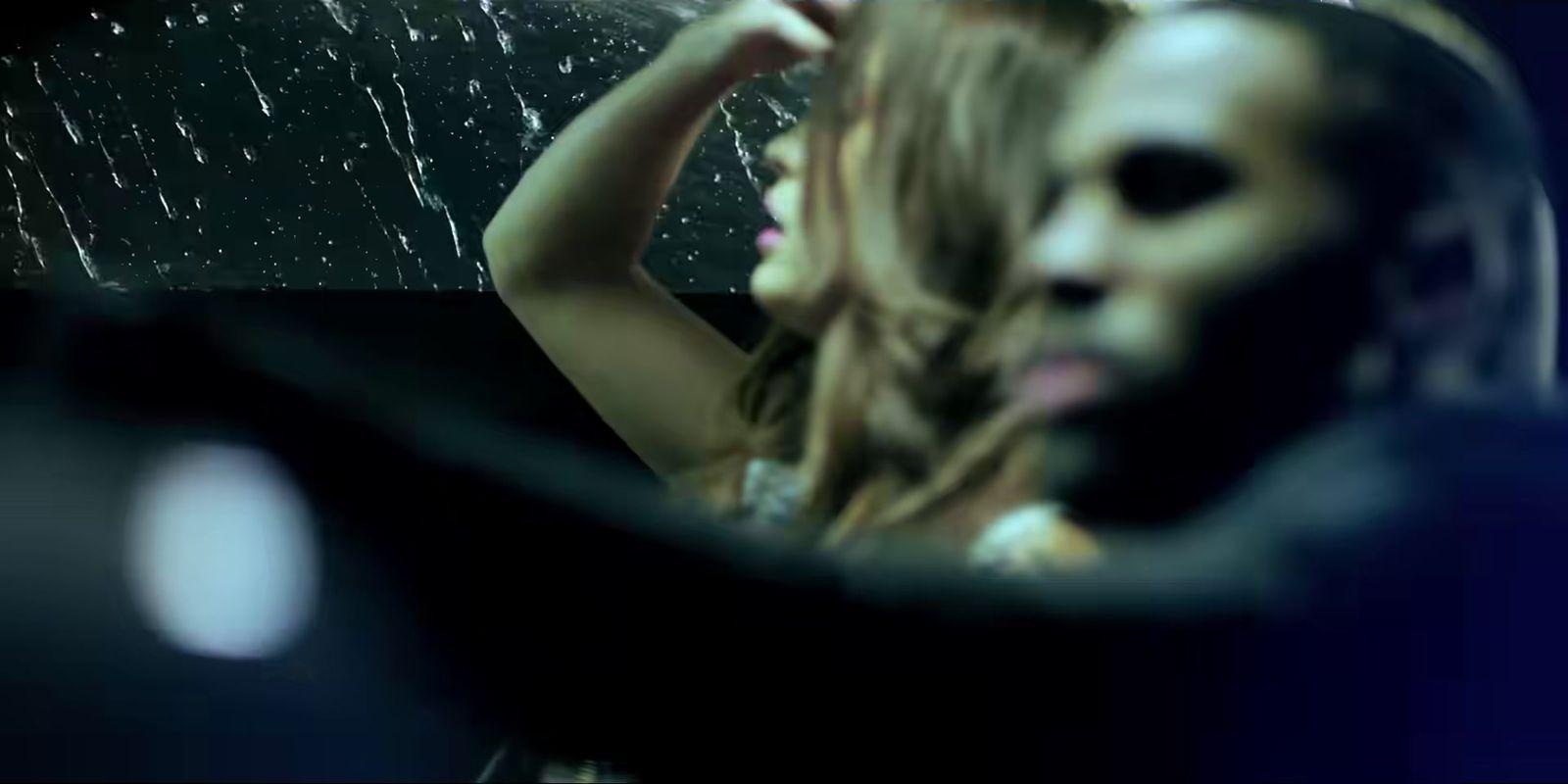 a woman brushing her hair in the mirror