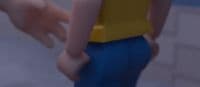 a close up of a person's hand holding a yellow object