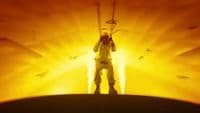 a man standing in front of a yellow light