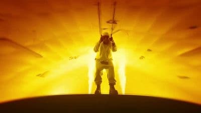 a man standing in front of a yellow light