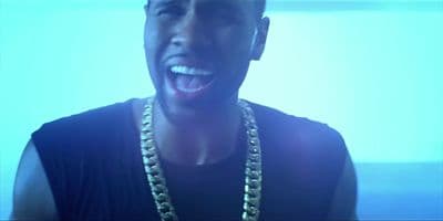 a man wearing a gold chain and a black shirt