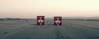 a couple of red boxes sitting on top of an airport runway