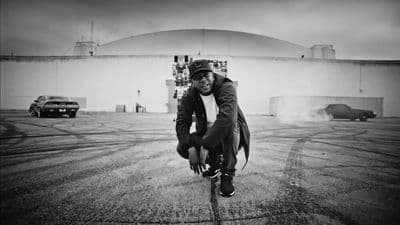 a man riding a skateboard across a parking lot