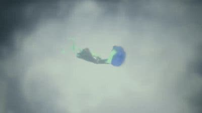 a kite flying through a cloudy sky on a cloudy day