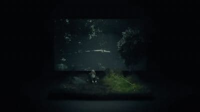 a person sitting in the dark with a flashlight