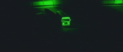 a bus parked in a parking lot at night