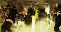 a group of young men dancing in a smoke filled room