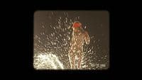 a man in a red hat is spraying water