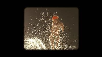 a man in a red hat is spraying water