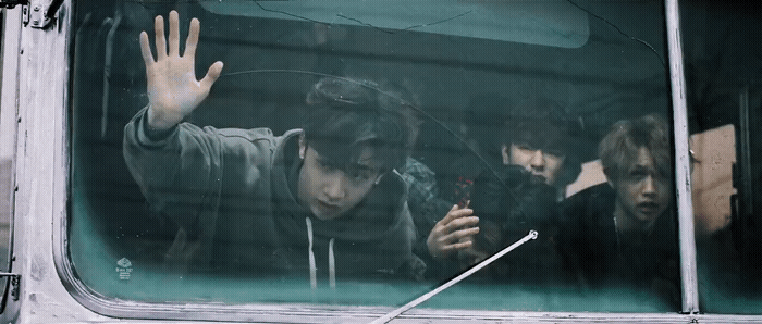 a group of young men riding on the back of a bus