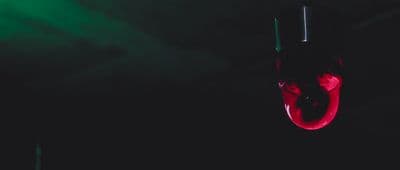 a black and green background with a red umbrella