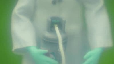 a close up of a person wearing gloves holding a toothbrush