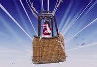 a man sitting on top of a hot air balloon