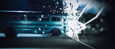 a bus parked in front of a wall with graffiti on it