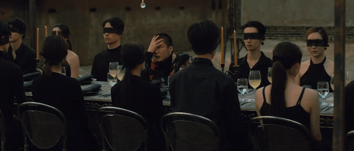 a group of people wearing blindfolds around a table