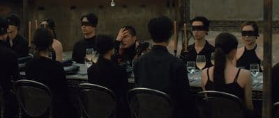 a group of people wearing blindfolds around a table