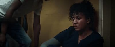 a woman sitting in a room next to a man