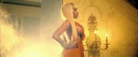 a woman with long blonde hair standing in a room