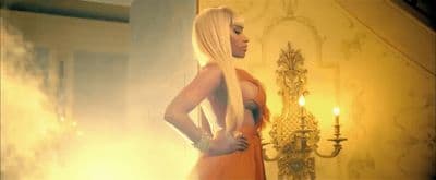 a woman with long blonde hair standing in a room