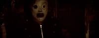 a person wearing a mask in a dark room
