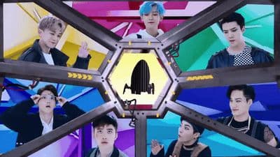 a group of young men standing in front of a tv screen
