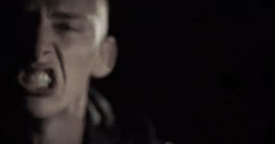a man with his mouth open in the dark