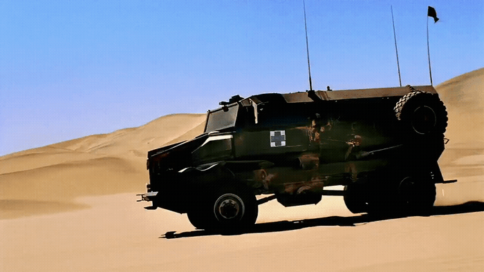 a military vehicle driving through the desert