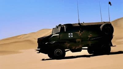 a military vehicle driving through the desert