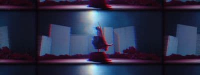 a person standing on a stage with their arms in the air