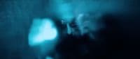 a blurry image of a person in a dark room