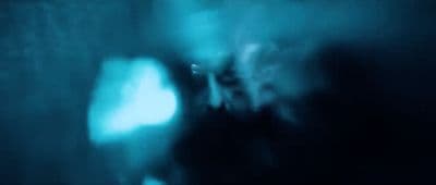 a blurry image of a person in a dark room