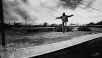 a man riding a skateboard on top of a cement slab