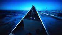 a woman standing in the middle of a pyramid