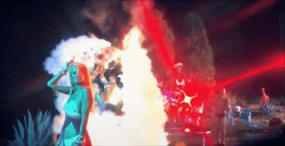 a woman standing in front of a fire with her hands on her head