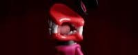 a close up of a red and black object with teeth