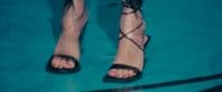 a close up of a person's feet wearing sandals