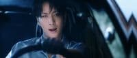 a woman driving a car in the dark