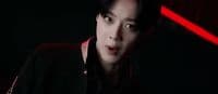 a man in a dark room with a red light