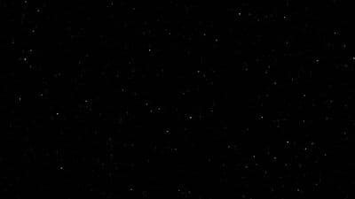 a black and white photo of the night sky