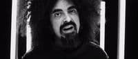 a black and white photo of a man with long hair