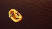 a yellow raft floating on top of a body of water