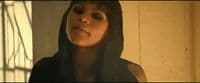 a woman with a hood on looking up