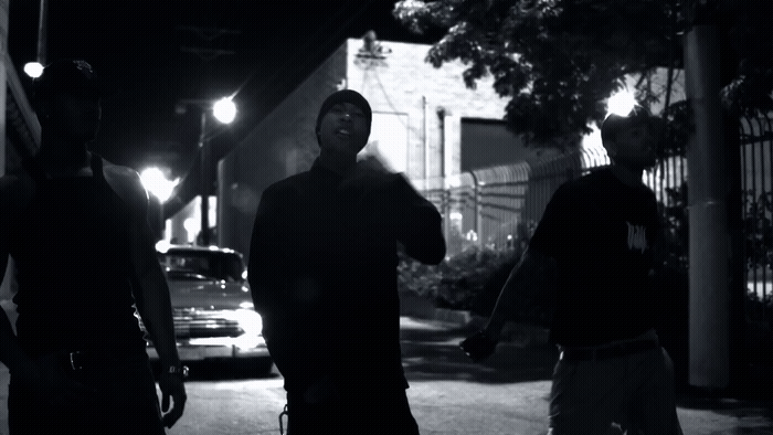 a group of men walking down a street at night