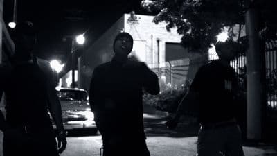 a group of men walking down a street at night