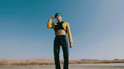 a woman standing in the middle of a desert