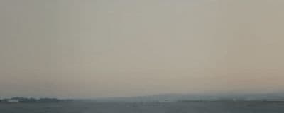 an airplane is flying over a large body of water