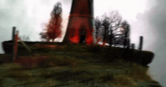 a blurry picture of a lighthouse on top of a hill
